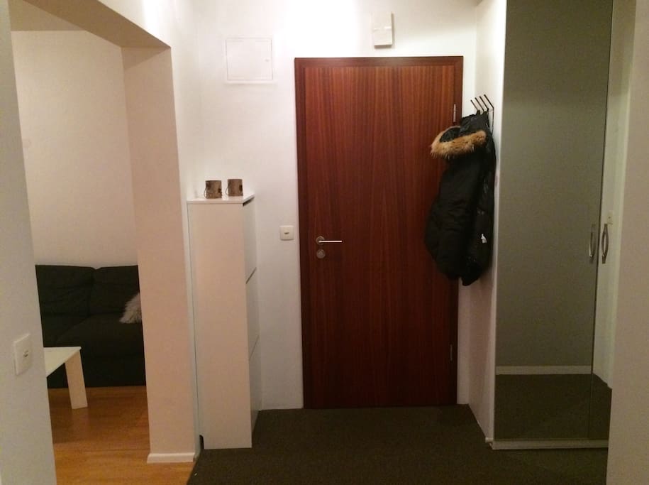 This is the first view of our hallway that leads to the staircase connecting all of the apartments in the building. On the left is the living room and to the right is the bathroom.