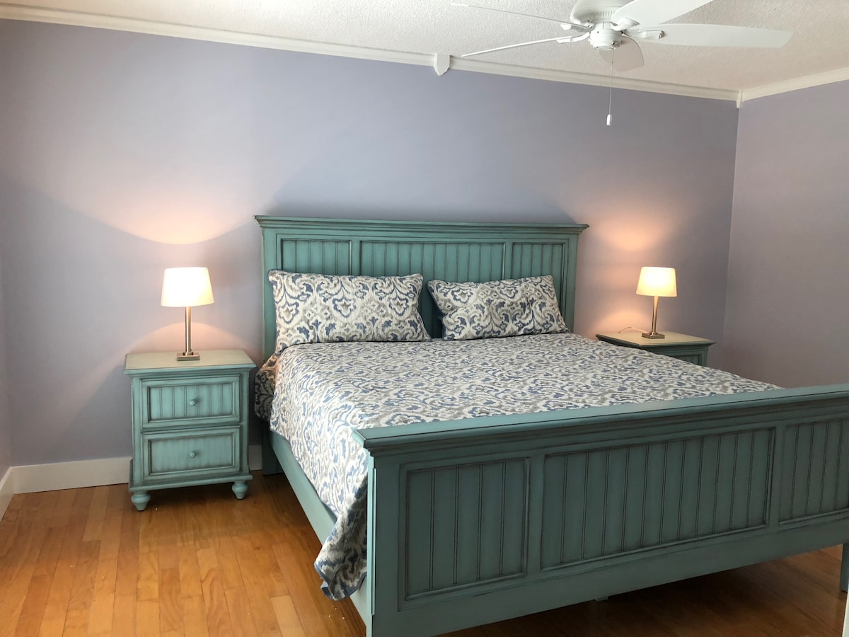 The first master bedroom with a kingsize bed on the second floor with an en suite bathroom