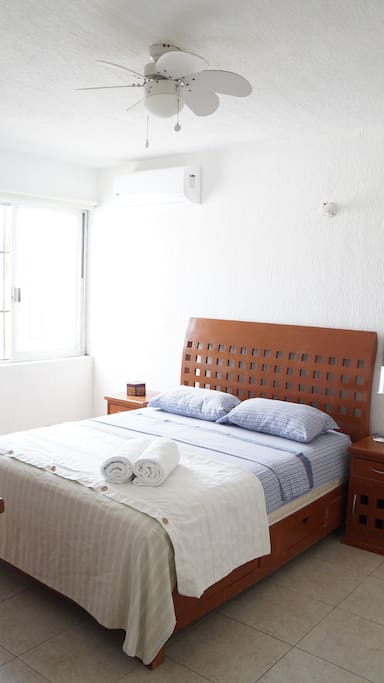 Your confortable queen bed with towels, air conditioner and fan