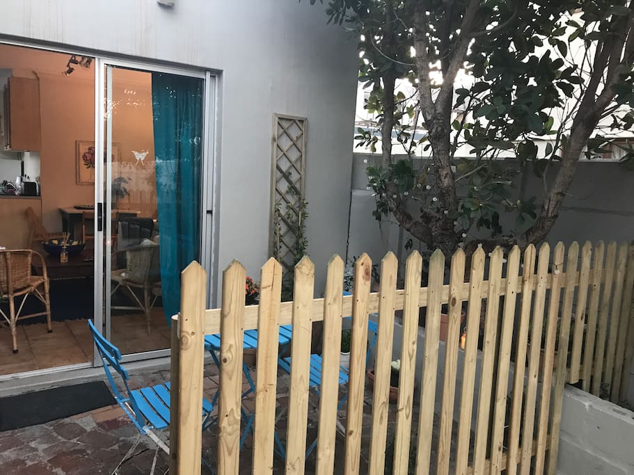 Entrance area with small patio and a fountain sectioned off from the driveway for privacy