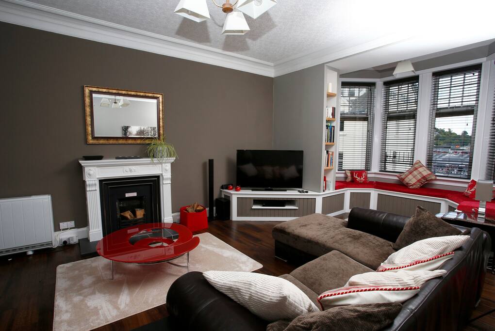Living room with bay window seating providing panoramic views towards the sea