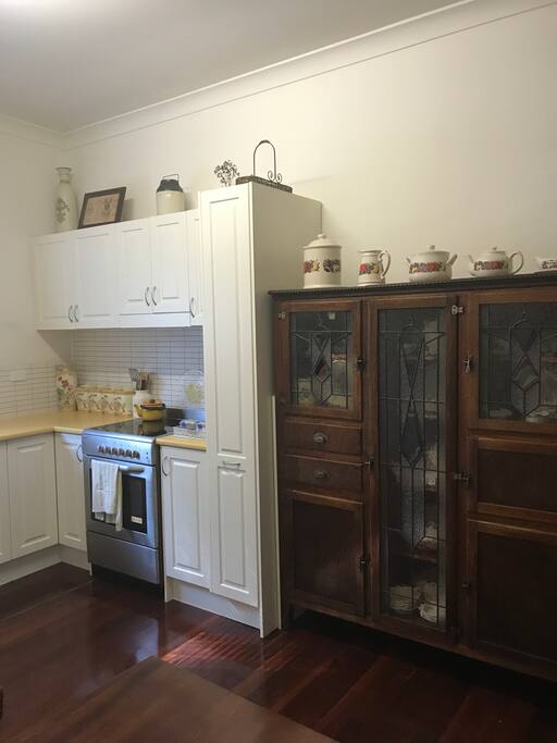 A modern kitchen with oven, microwave & full size refrigerator, but with an old world feel,