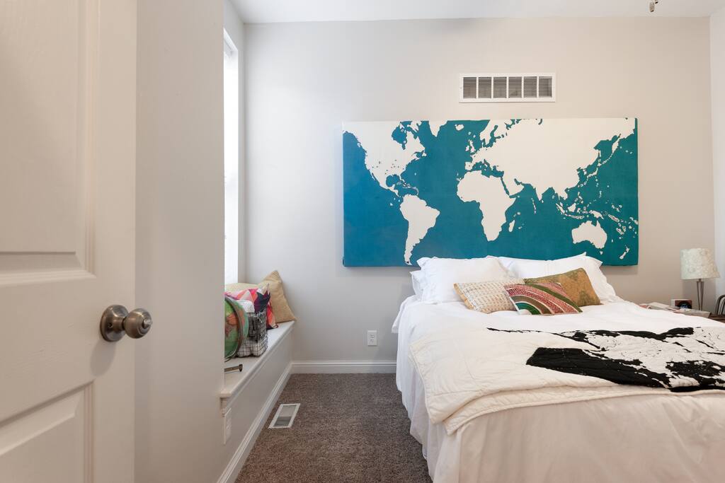 The "map room" a comfortable place to rest! It has a queen bed, luggage stand and an alarm clock with a sound machine!