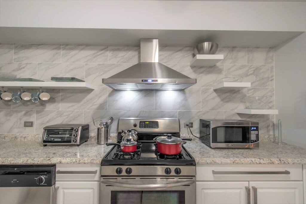 Newly remodeled kitchen with stainless steel appliances, stocked with all supplies needed for a home-cooked meal