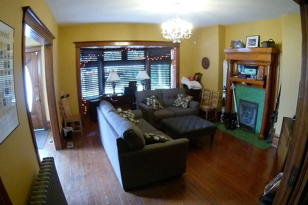 Main entrance seen in cover photo pictured on the left, opening up into a large hallway and living room area seen here.