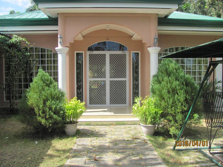 Entrance to suite passing spacious garden and private covered swing