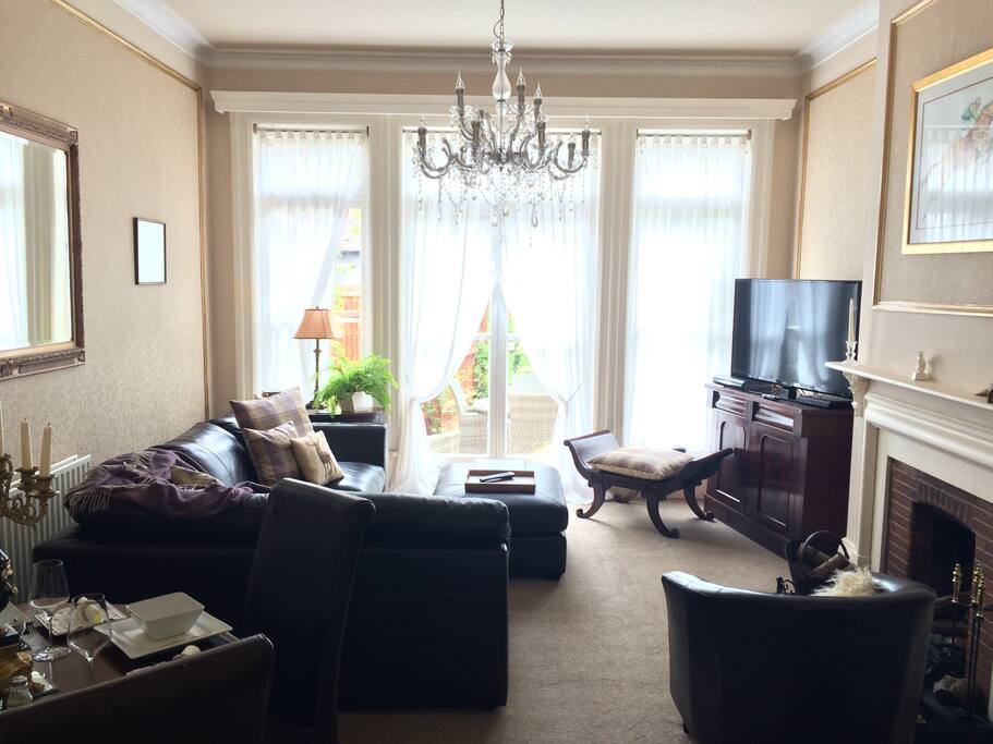 Sitting room with doors leading to private patio with outdoor furniture