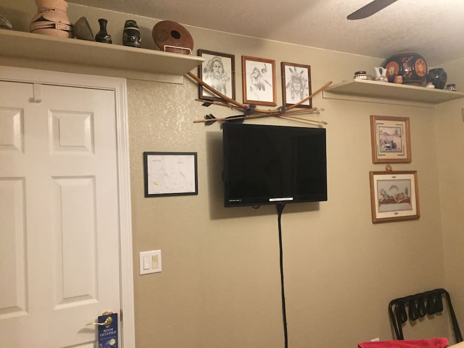 West room flat screen , Native pottery, hand drawn art and bow and arrow.