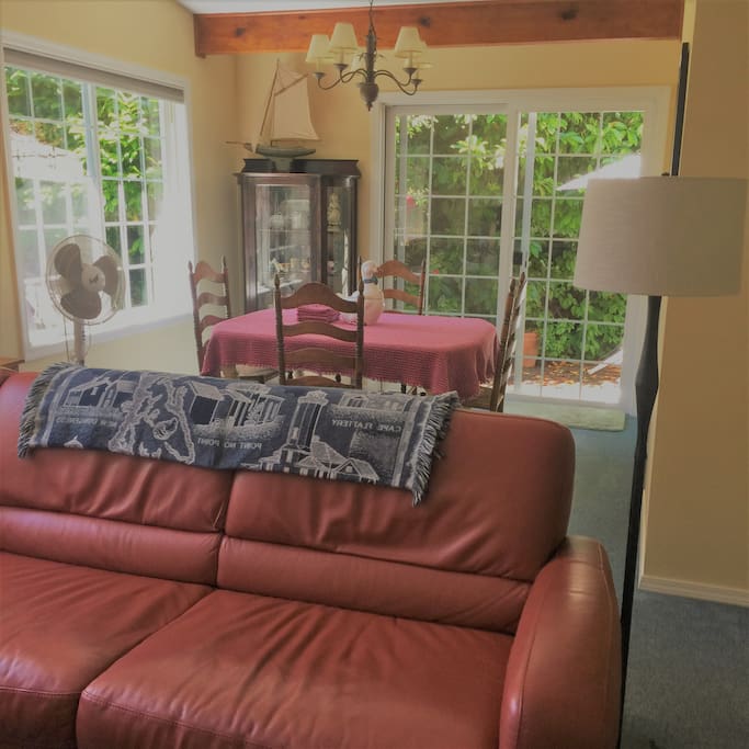 Your home away from home! You will enter through the front door with keypad which allows late arrival. Note the leather sectional in the living room and the dining area beyond.