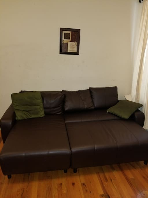 This is a leather pull out couch Double Bed