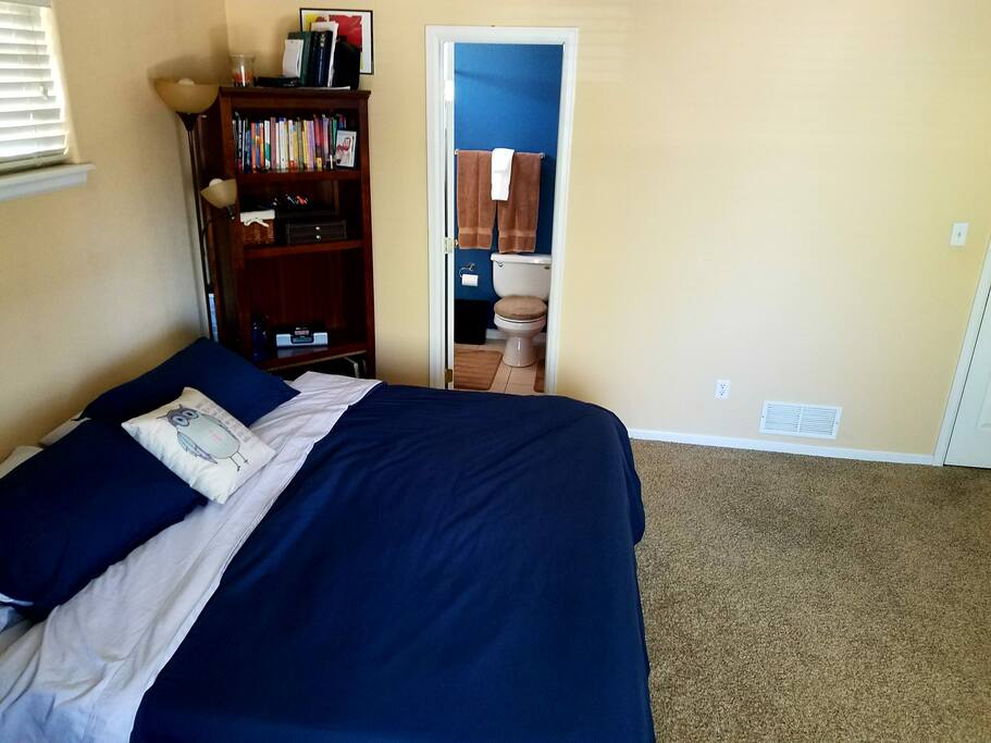 King-sized memory foam bed, along with the master bathroom doorway.