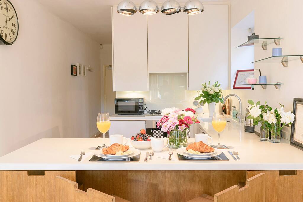 Modern chairs at the kitchen bar are perfect for casual meals at home