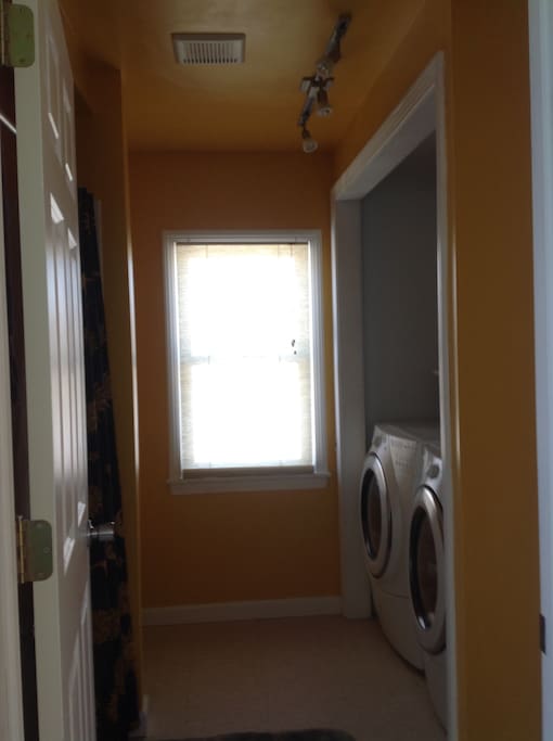 View into bathroom with washer and dryer.