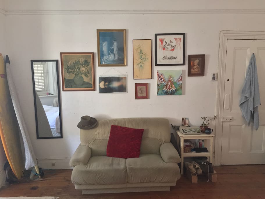 Here is your couch, two tri-finned shortboards, a changing mirror, and art collection from local Cape Town artists.