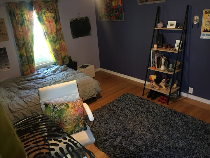 Third, purple bedroom with full size bed.