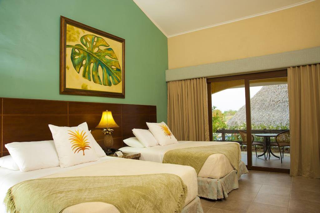 Suite Double
Bedroom w/ 2 Double Beds and Living Room w/ Sofabed, for up to 6 Guest
Our roomiest Suite feature a bedroom with two double beds and a living room with kitchent and a sofabed.
This is the ideal room for the bigger groups or a family that want to spend some time together.
The private garden with terrace is ideal for the kids to play while you relax in your hammock.
The Suite also features: 2 LCD TVs w/cable, radio, telephone, bathroom with hot water and bespoke amenities