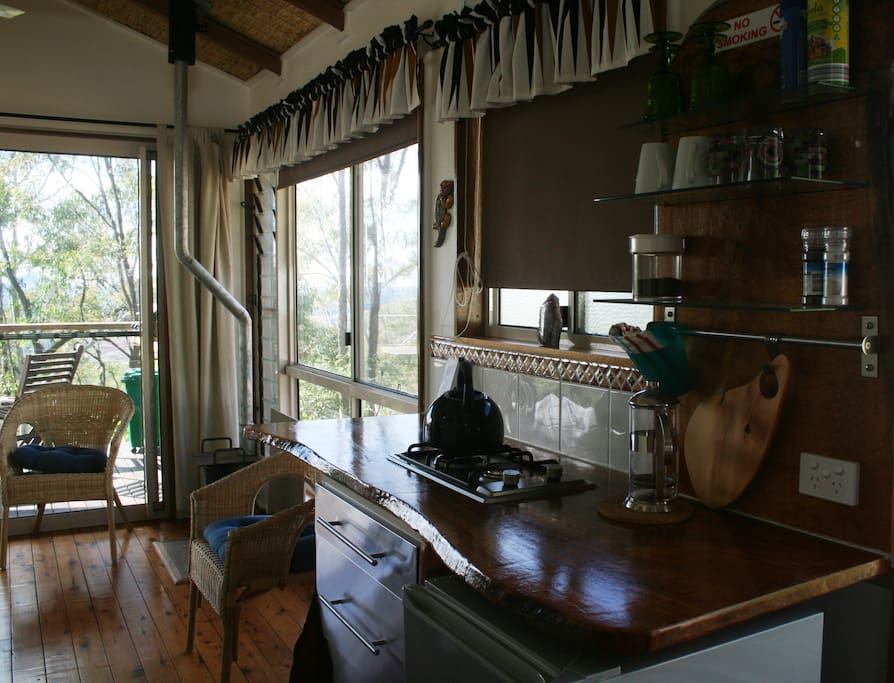 View of the cabin kitchen bench with two burner cooktop/ fridge .