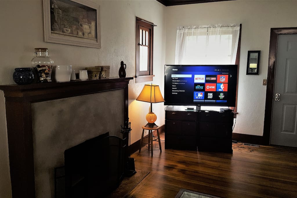 Cozy living room with fireplace and large flat screen TV hooked up to a Roku streaming device. Many channels available including Netflix.
