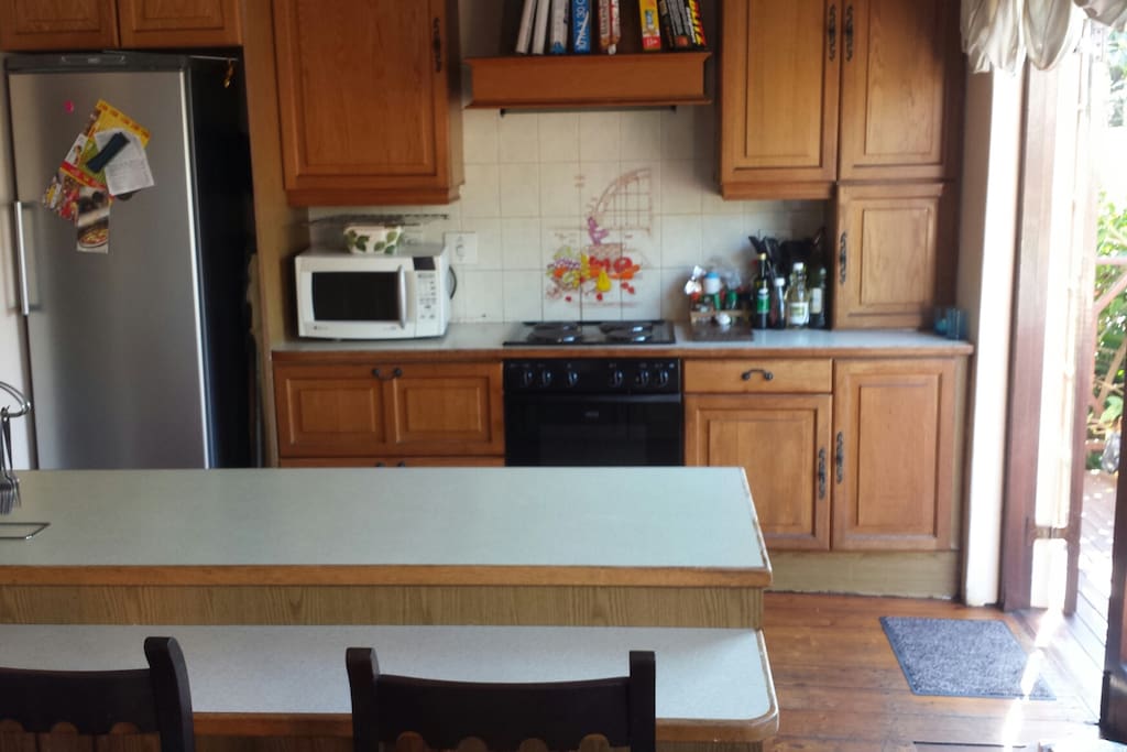 Open plan kitchen with scullery on left of fridge