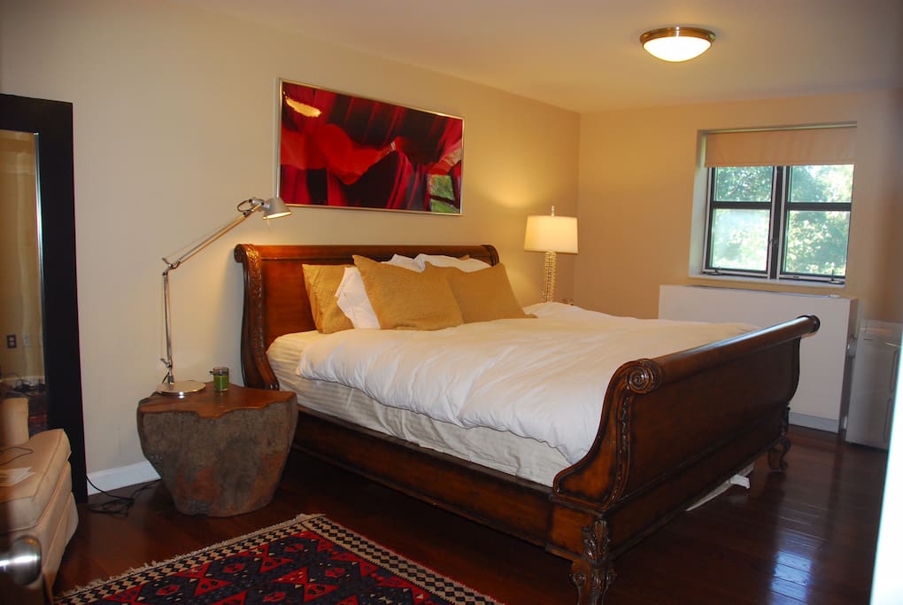 Master’s bedroom with a private full bathroom and a king size bed