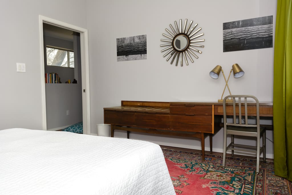 Room is fully furnished with bed, bedside tables on both sides, a desk/dresser, and a small armoire for hanging things.
