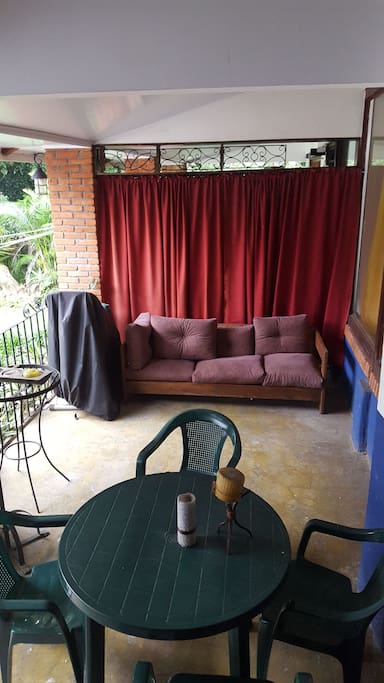 Guests have access to the quaint outside terrace with full couch for relaxing and another set of table and chairs for eating breakfast outside and enjoying the sound of the river and lovely trees.