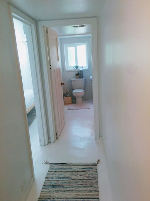 Hallway to bathroom with shower only.