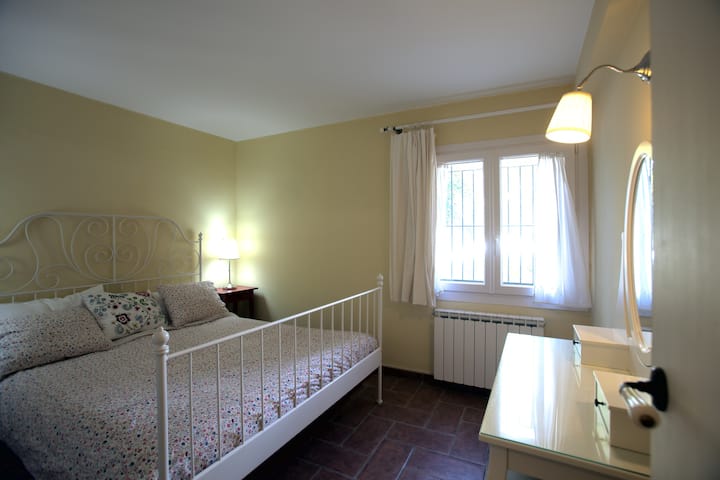 Bedroom with a double bed and dressing table with stool, which can be also used as a work place for your computer. 