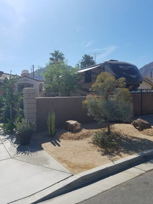 The RV is tucked away behind a 6' wall.