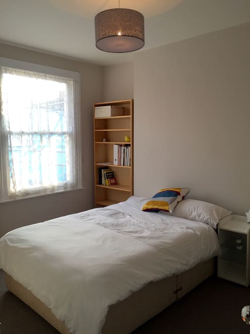Light, bright, newly decorated double bedroom with bookshelf