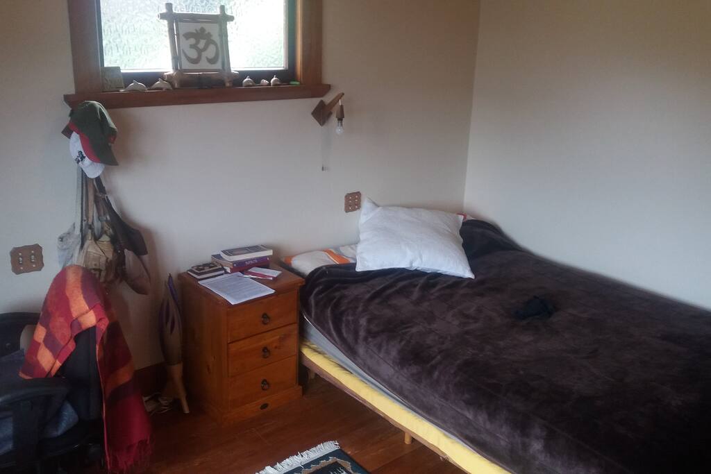 Comfy double bed, with side table, the view is great even when you are lying down!