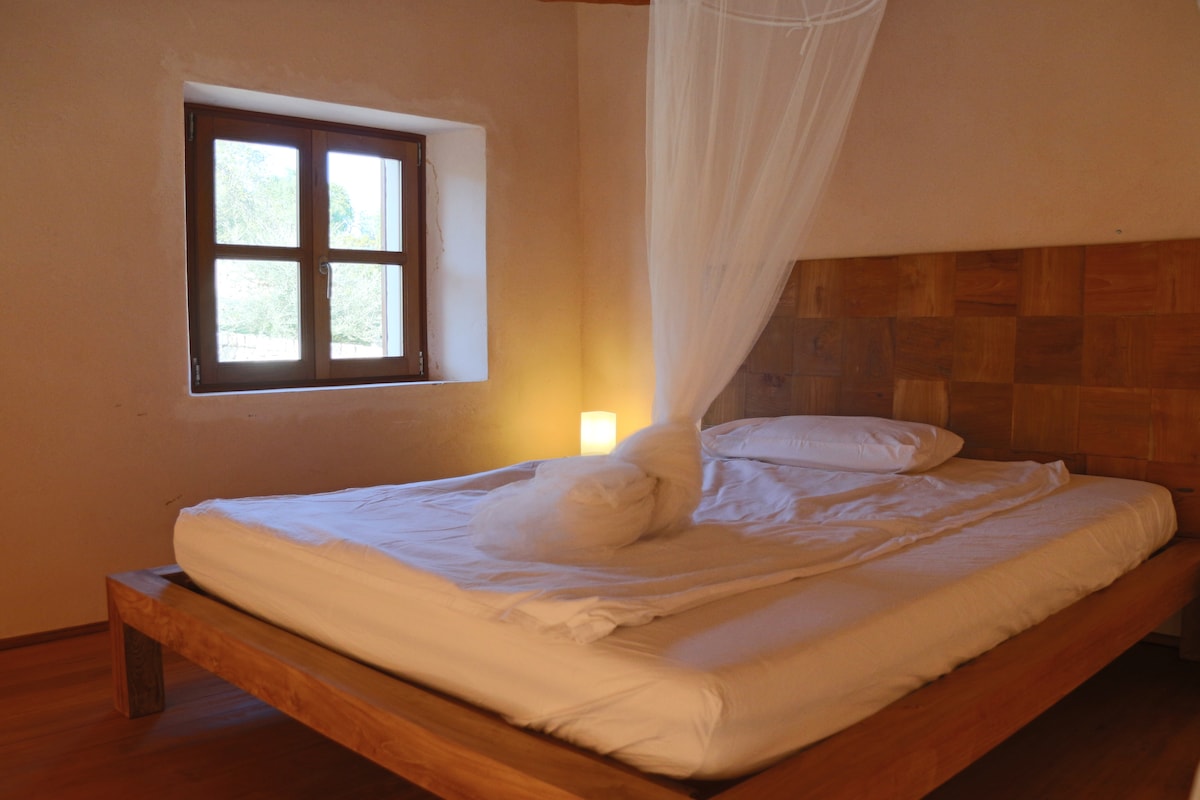 Double bed on the gallery level of a mountain view suite