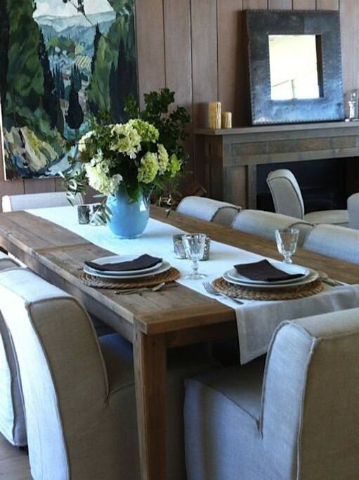 Dinning room with a view to the Pacific, beautiful cutlery and crockery, wood stove