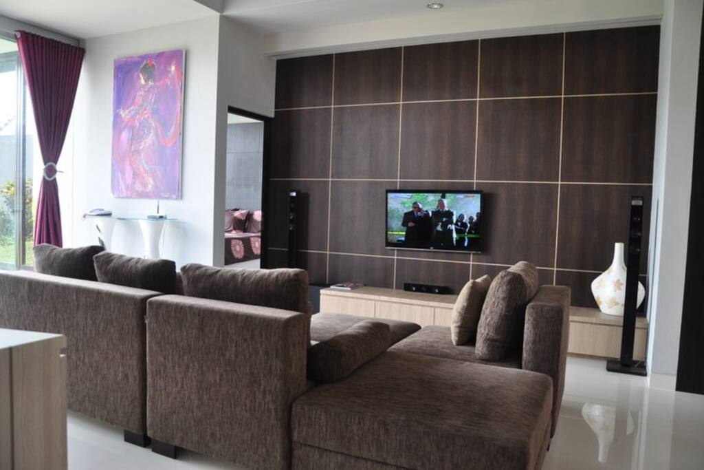 Living room with TV and satellite channels plus a home theater screen