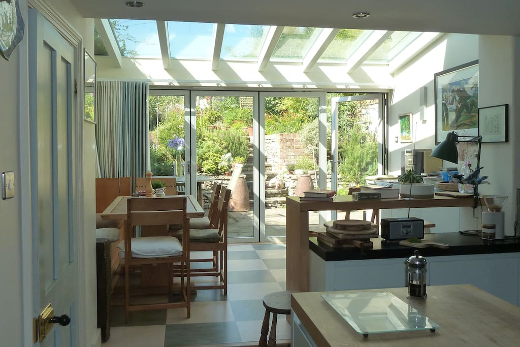 The dining area through the kitchen with beautiful handmade table and chairs. The folding sliding doors lead through to the garden where guests can sit up on the lawn and enjoy peace and privacy yet only five minutes away from the centre of the town.