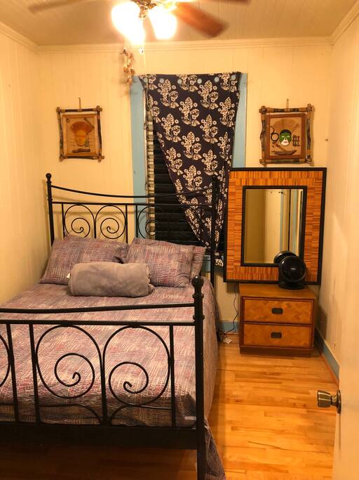 Bedroom #1: Queen size bed, ceiling fan, portable fan, mirror, small closet and drawer.