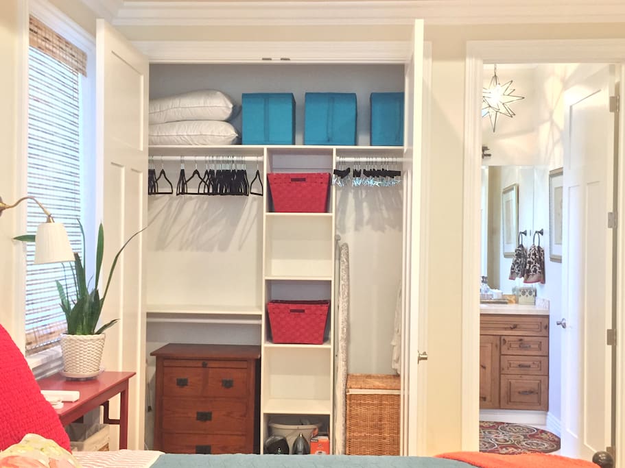 Generous closet with plenty of storage, hamper, iron, fan.