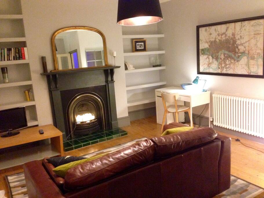 Comfortable living room with TV and work area.