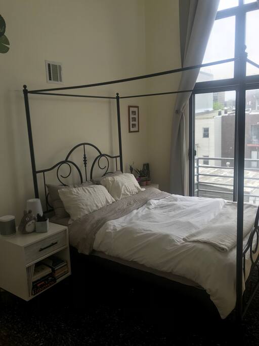 Light filled bedroom with tall ceilings