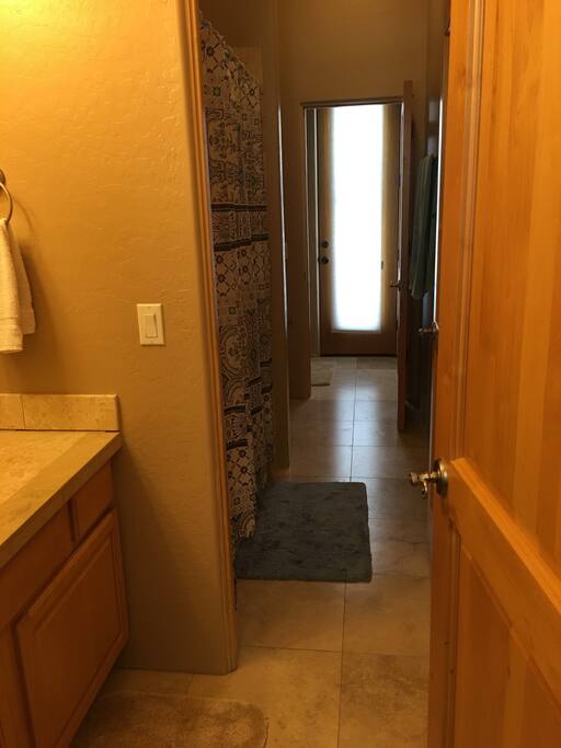 Two bedrooms share a Jack and Jill bathroom with bathtub, shower over bath , toilet and separated hand basins.
