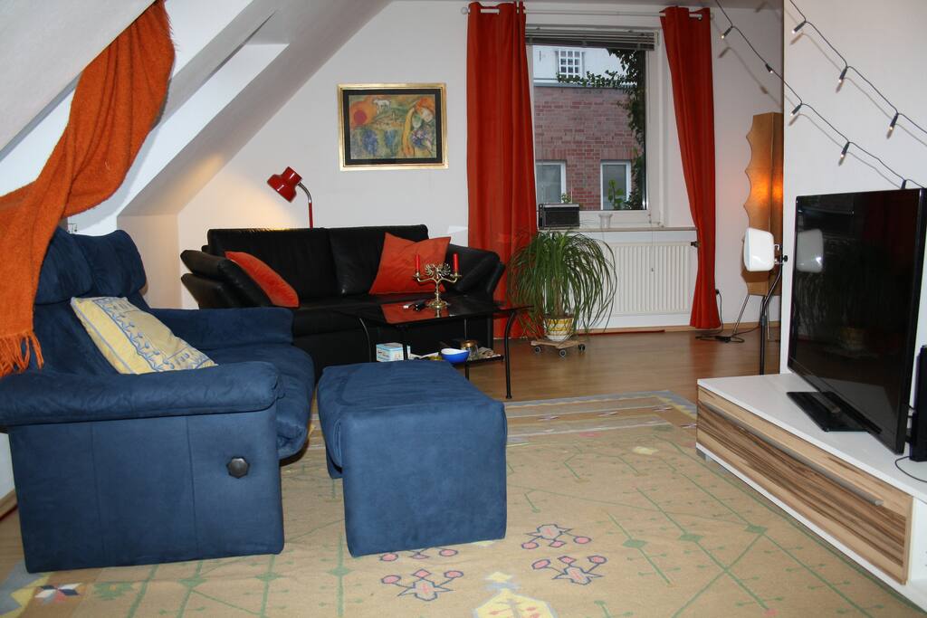 Living room with two luxury couches. The black one is a full size double bed.