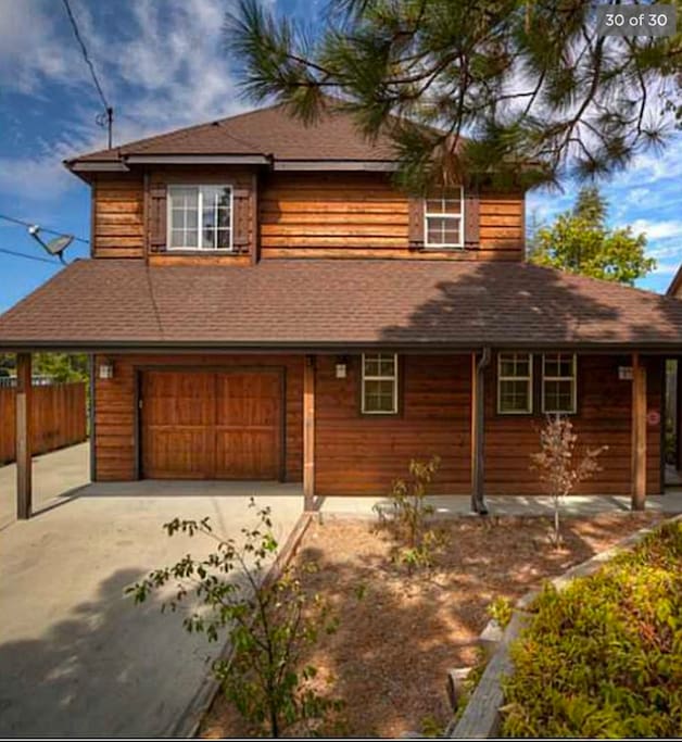A flat driveway provides ample parking for multiple cars, or a large van and car, plus there's a one-car garage.