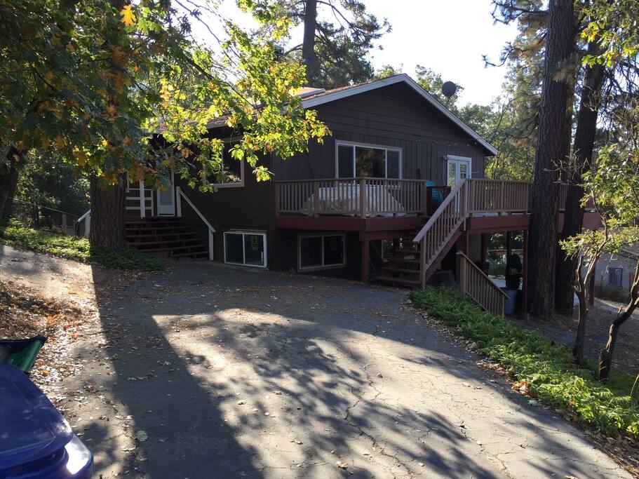 Exterior view from the driveway. The driveway is long and easily fits three cars (tandem parking). A second driveway (far left) allows the car in front to come and go without re-parking other vehicles.