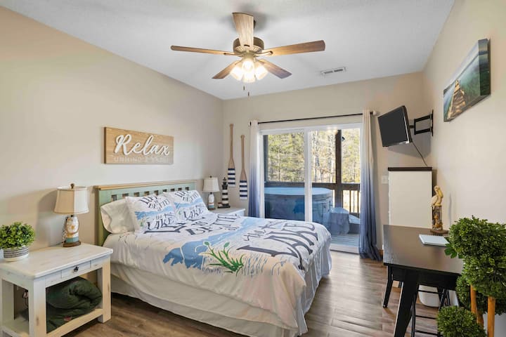 Enjoy waking up to views of the lake in the downstairs Lake room. This room has a queen size bed and a desk. No worries about having a private place to work, we have you covered. You will also have access to the hot tub from this room.