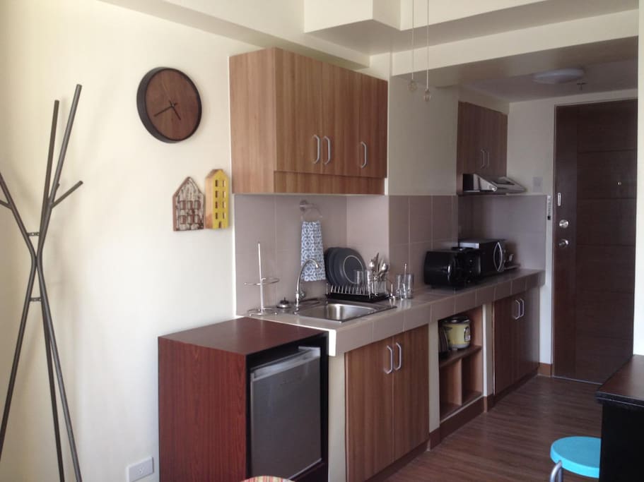 Kitchen with min-fridge, microwave oven, toaster, coffee maker and convection range