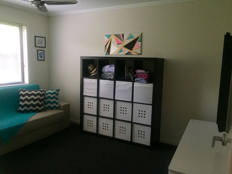 Bedroom that has a sofa lounge that converts into a queen sized bed. This room has a wall mounted tv.