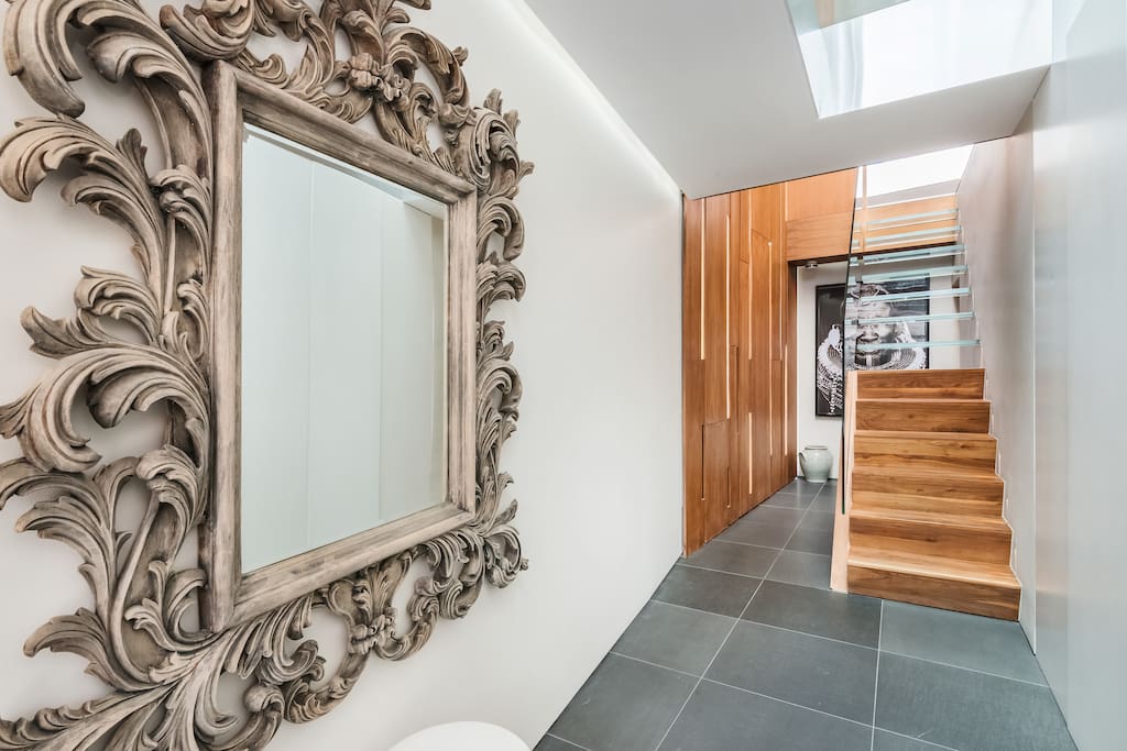 Spacious entrance hall with view of the beautiful staircase to the Upper Level