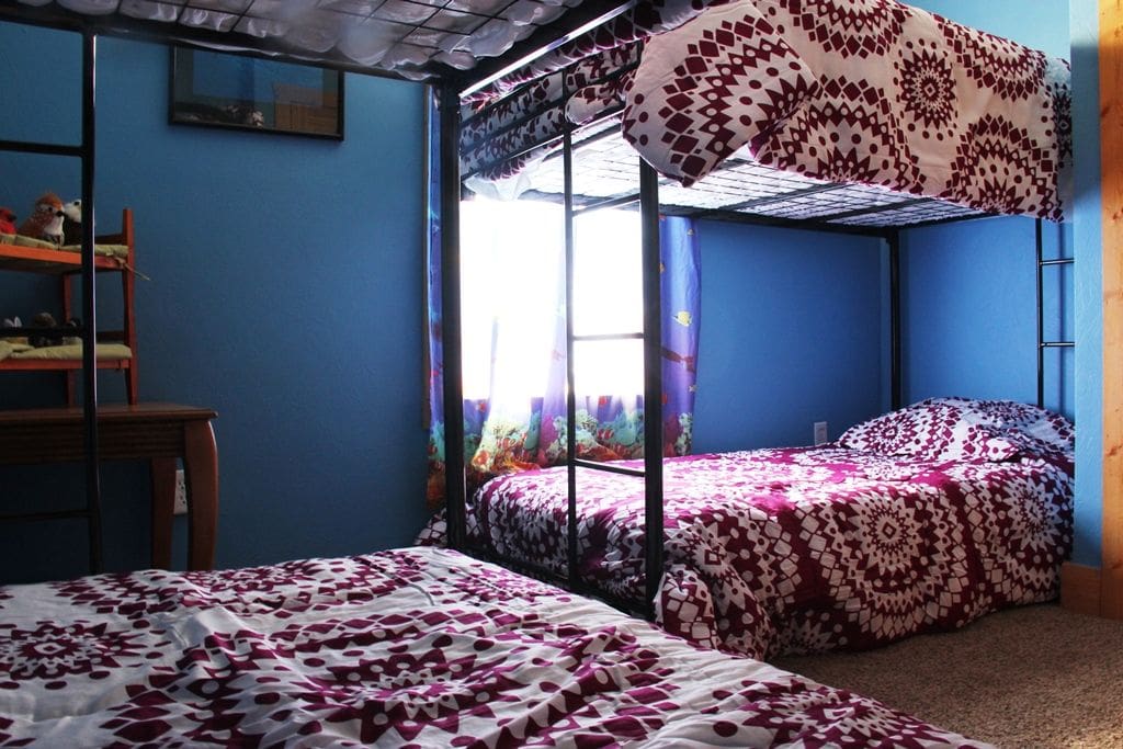 2 bunk beds in a cheery room