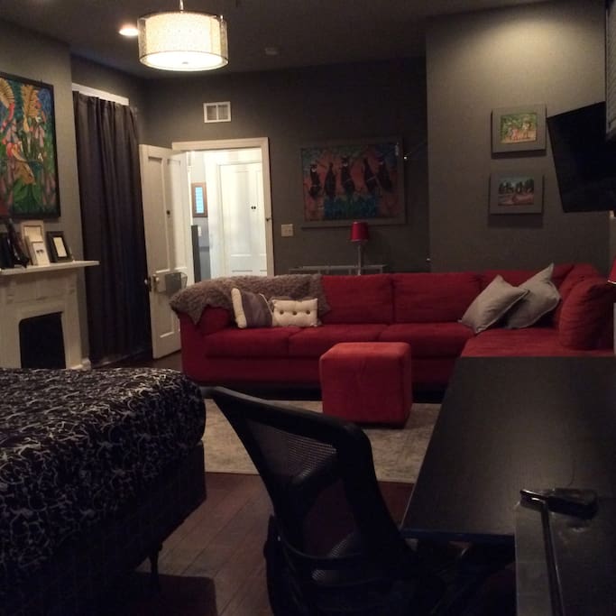 The room is spacious with a comfy sectional sofa for napping, relaxing or enjoying the big screen TV