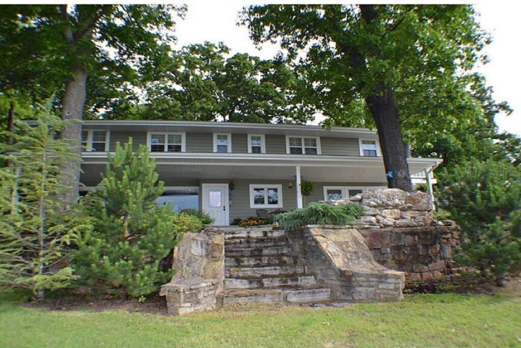 View of the grand back patio showing stone work and landscaping.